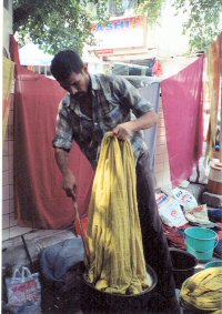 Man in market dying fabric